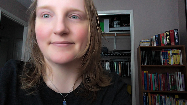 Me in 2019. I've mentioned I'm awful in front of a camera, yes? But look at my old collection of foreign language books on the bookshelf behind me.❤️